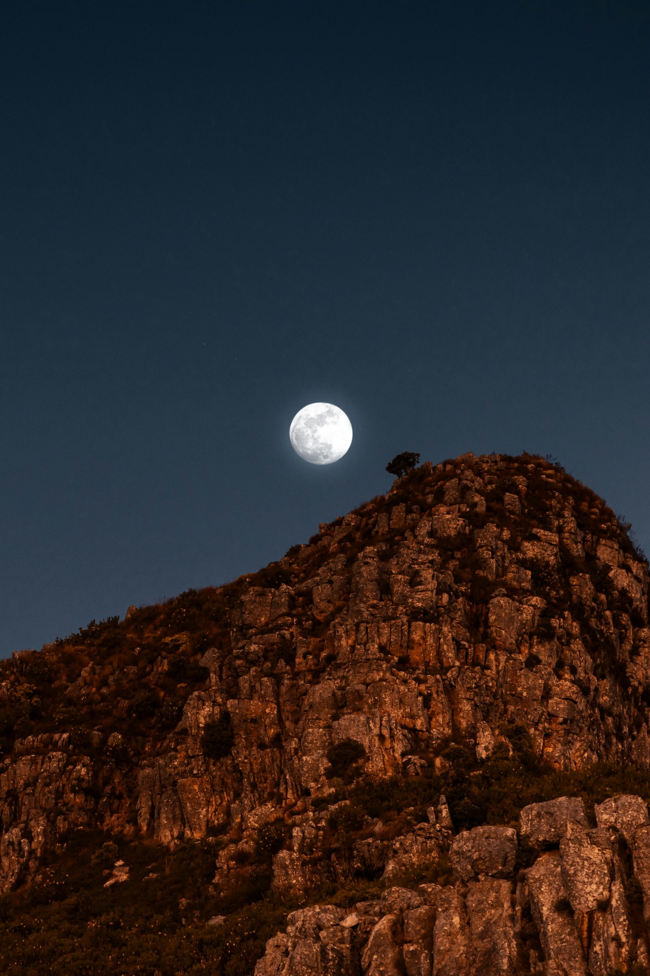 Moon rising over a South African mountain peak